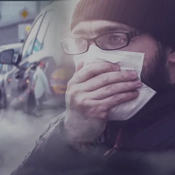 Mann hält sich wegen Autoabgasen Hand vor den Mund